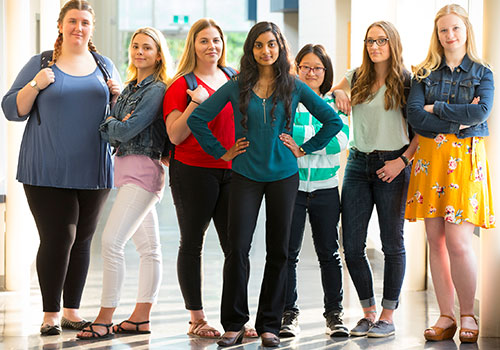 Row of students standing in a bold pose